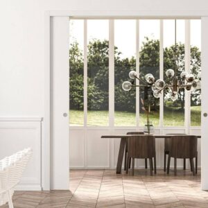 Modern living and dining room with large windows.